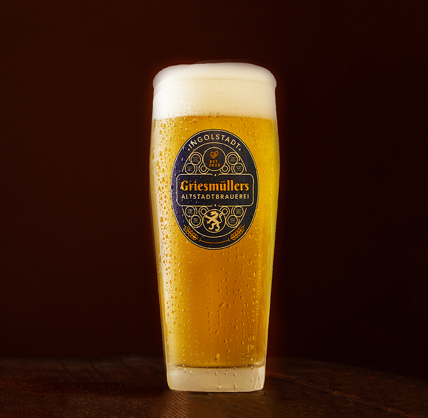 Griesmüllers Altstadtbrauerei glass of Pils with foam head on a dark backdrop