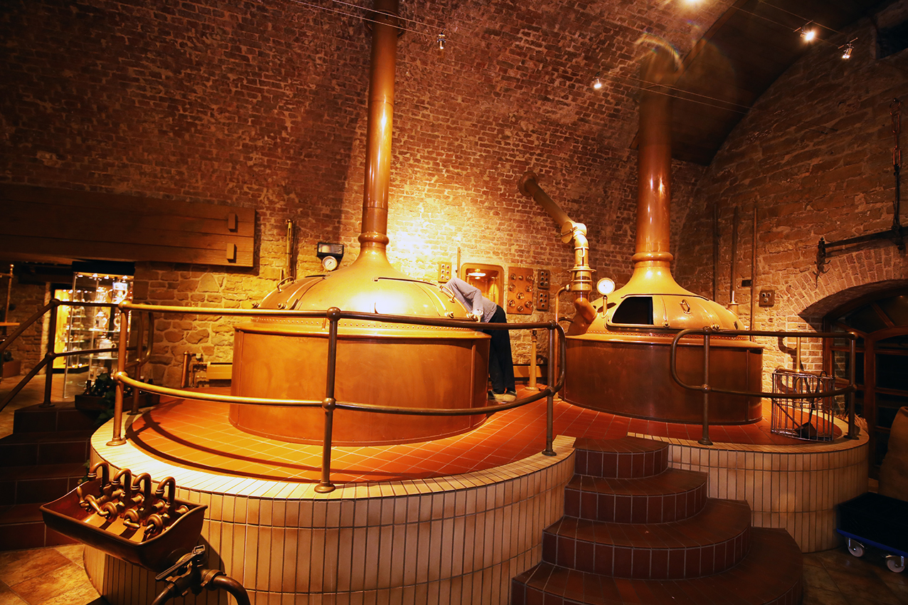 The historic copper brewhouse beneath brick vaulting
