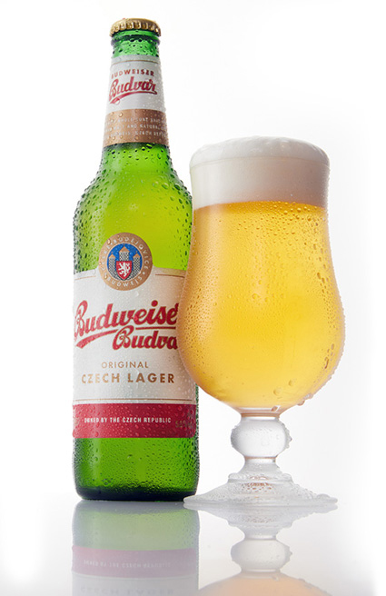 Budweiser Budvar Czech Lager bottle beside a freshly poured tulip glass