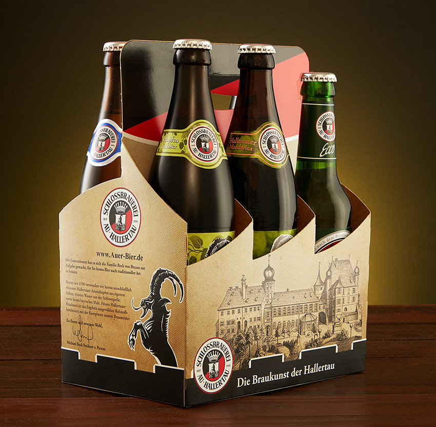 Schlossbrauerei Au-Hallertau six-pack carrier holding four beer bottles