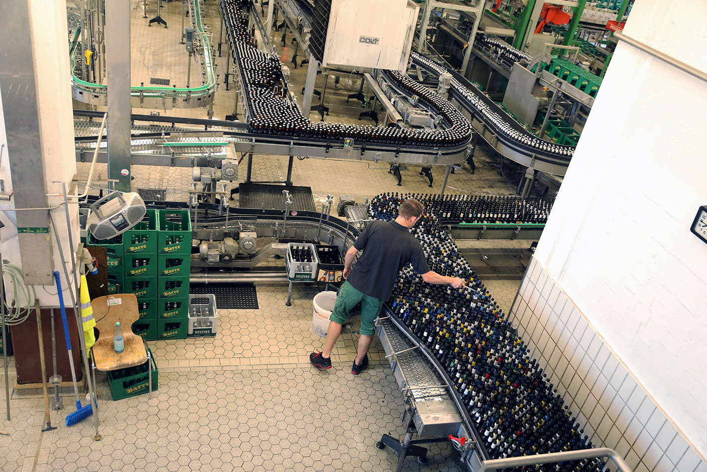 Wide overhead view of the Barre bottling operation with conveyor systems and a worker handling bottles