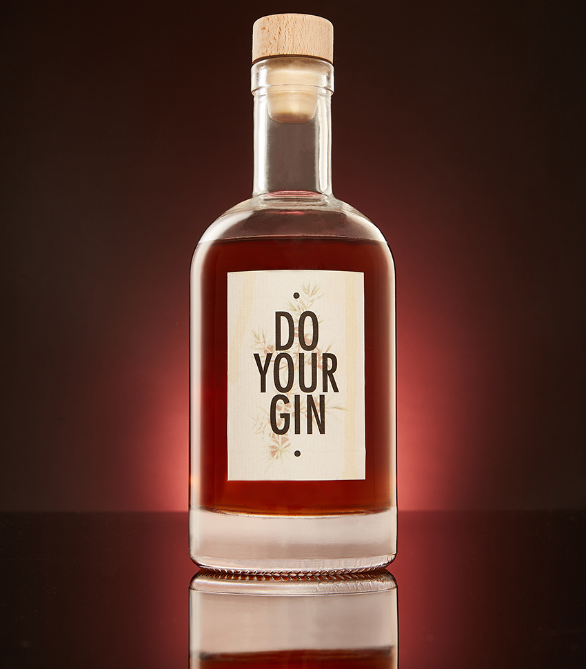 Do Your Gin bottle with cork stopper on a reflective dark red surface
