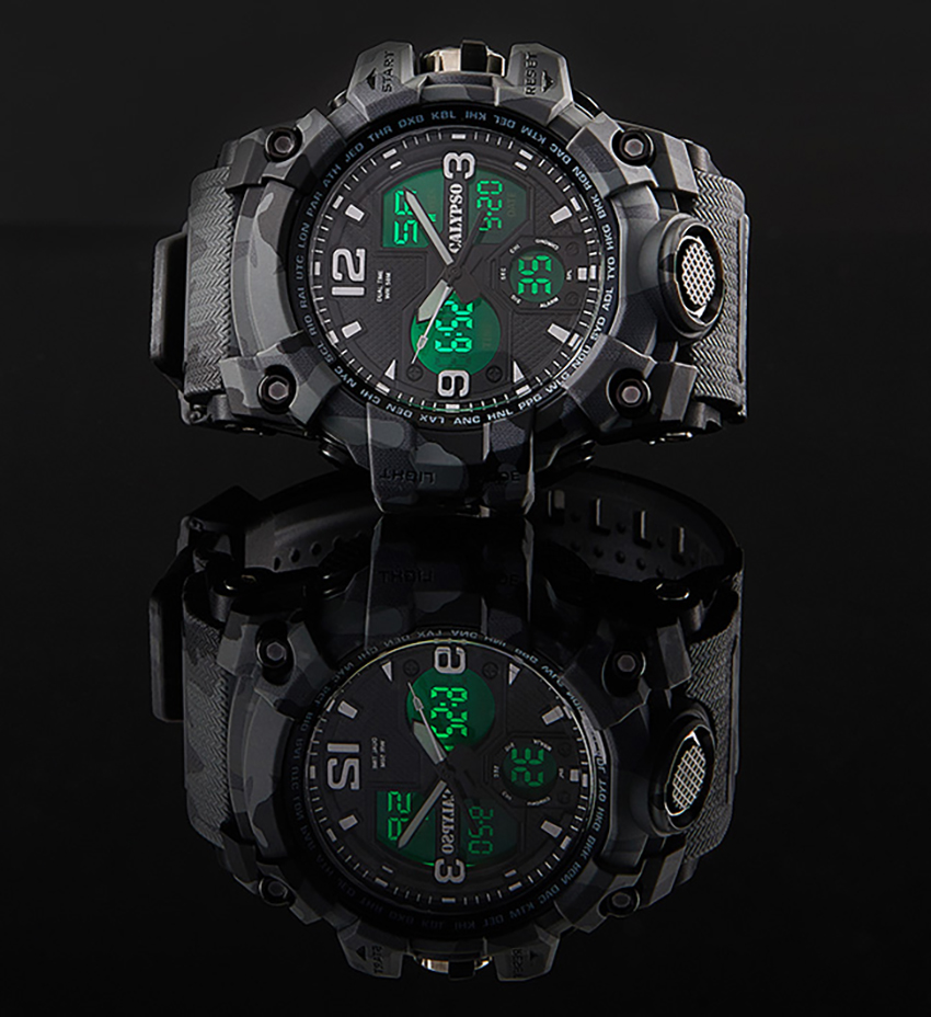 Calypso black watch with green digital display and reflection on a black surface