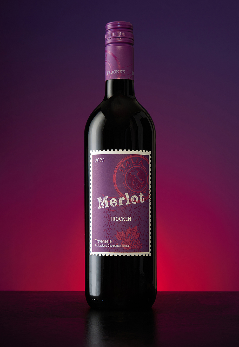 A Merlot bottle against a deep purple and magenta gradient backdrop