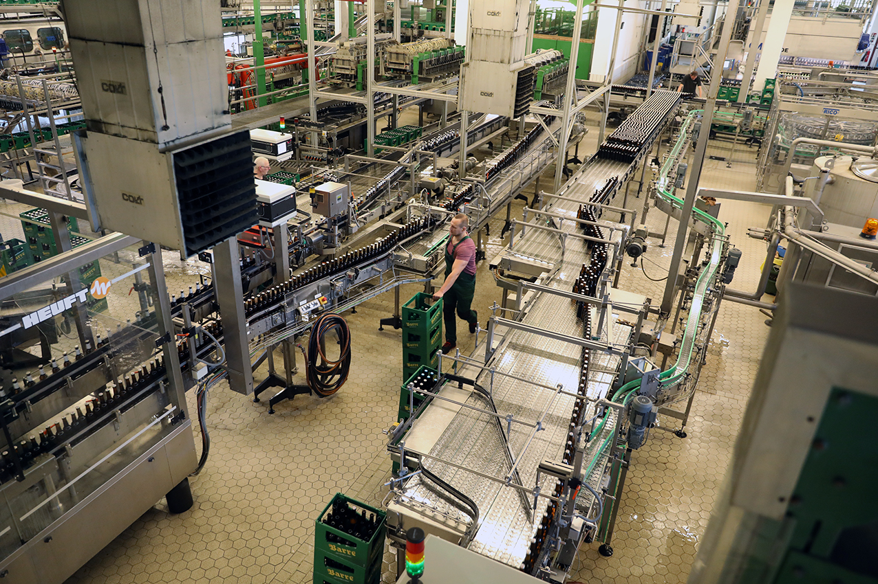 An elevated view across the Barre bottling hall with its conveyors and crates